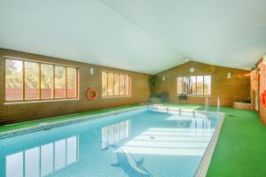 a large swimming pool in a room with at 2 Bed in Smallburgh oc-m33732 in Dilham