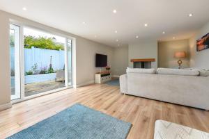 a living room with a couch and a television at 4 Bed in Abersoch oc-egrypo in Abersoch