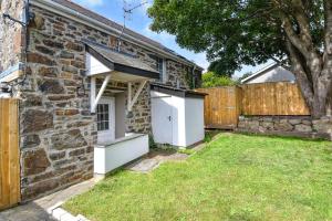 a stone house with a garden and a fence at 4 Bed in Abersoch oc-egrypo in Abersoch