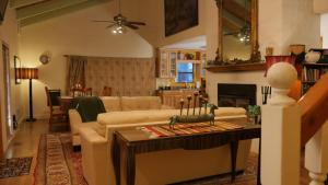 a living room with a couch and a table at Artist Chalet in Flagstaff