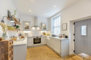 a kitchen with white cabinets and a large window at 3 Bed in Carperby oc-ds058 in Carperby