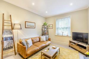 a living room with a couch and a television at 3 Bed in Carperby oc-ds058 in Carperby