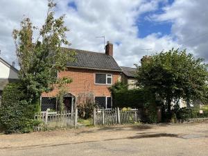 a brick house with a fence in front of it at 2 Bed in Dennington oc-b28010 in Dennington