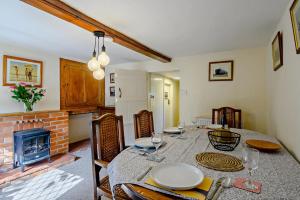 a dining room with a table and a fireplace at 2 Bed in Dennington oc-b28010 in Dennington