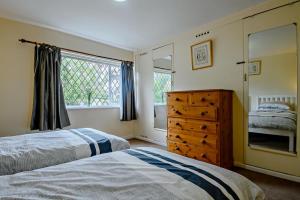 a bedroom with two beds and a dresser and a window at 2 Bed in Dennington oc-b28010 in Dennington