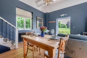a dining room with blue walls and a wooden table at 1 Bed in Tollard Royal oc-t29453 in Tollard Royal