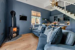 a living room with a blue couch and a fireplace at 1 Bed in Tollard Royal oc-t29453 in Tollard Royal