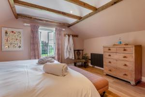 a bedroom with a large white bed and a dresser at 1 Bed in Tollard Royal oc-t29453 in Tollard Royal