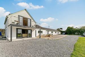 a house with a gravel driveway in front of it at 5 Bed in St. Merryn oc-t27899 in Saint Merryn
