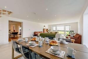 a dining room with a table and a living room at 5 Bed in St. Merryn oc-t27899 in Saint Merryn