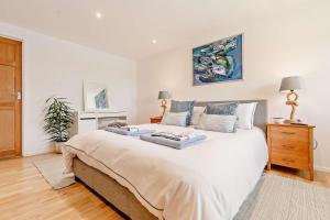 a bedroom with a large white bed with two pillows at 5 Bed in St. Merryn oc-t27899 in Saint Merryn