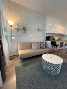 a living room with a couch and a table at Caesar Resort & SPA - Apartments Studio in Iskele