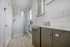 a white bathroom with a sink and a shower at 3 Bed in Treknow oc-h29194 in Treknow +26 photos