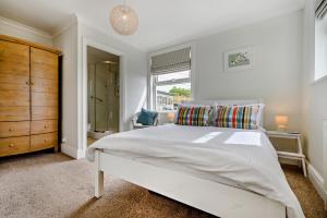 a bedroom with a large white bed and a window at 3 Bed in Treknow oc-h29194 in Treknow