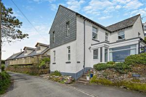 a white house with a gray roof at 3 Bed in Treknow oc-h29194 in Treknow