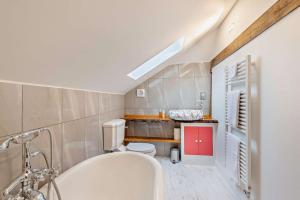 a bathroom with a white tub and a toilet at 2 Bed in Minster On Sea oc-p29942 in Minster +24 photos