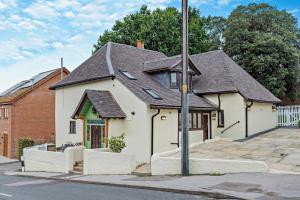 a white house with a black roof on a street at 2 Bed in Minster On Sea oc-p29942 in Minster