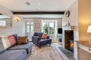 a living room with a couch and a fireplace at 2 Bed in Chideock oc-h29331 in Chideock