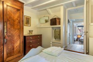 a bedroom with a bed and a wooden door at 2 Bed in Chideock oc-h29331 in Chideock
