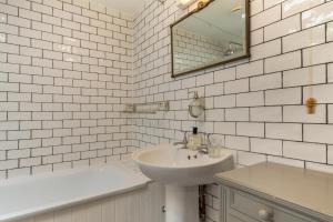a white bathroom with a sink and a mirror at 2 Bed in Chideock oc-h29331 in Chideock +20 photos