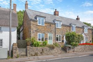 a brick house with white windows on a street at 2 Bed in Chideock oc-h29331 in Chideock