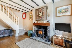 a living room with a fireplace and a tv at 3 Bed in Appersett oc-ds944 in Appersett