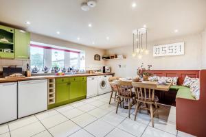 a kitchen with green cabinets and a table with chairs at 3 Bed in Appersett oc-ds944 in Appersett