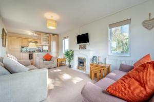 a living room with a couch and a fireplace at 3 Bed in St. Merryn oc-k30138 in Saint Merryn