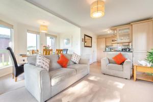 a living room with a couch and a table at 3 Bed in St. Merryn oc-k30138 in Saint Merryn