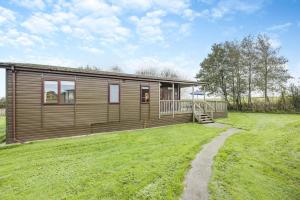 a log cabin with a grassy yard in front of it at 3 Bed in St. Merryn oc-k30138 in Saint Merryn