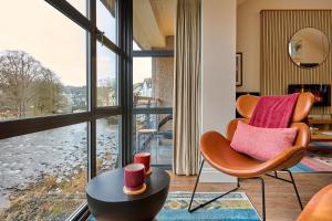 a living room with a chair and a table at Riverside Park 5 in Keswick