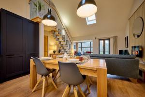 a dining room and living room with a table and chairs at Riverside Park 5 in Keswick