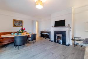 a living room with a table and a fireplace at 2 Bed in Felixstowe oc-m30281 in Felixstowe
