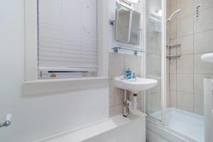 a white bathroom with a sink and a shower at 2 Bed in Felixstowe oc-m30281 in Felixstowe +13 photos