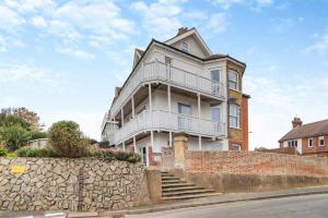 a large white house with a stone wall at 2 Bed in Felixstowe oc-m30281 in Felixstowe