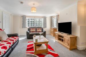 a living room with a couch and a flat screen tv at 3 Bed in Scethrog oc-h30013 in Scethrog