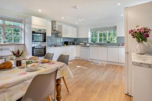 a kitchen with white cabinets and a table with food on it at 3 Bed in Scethrog oc-h30013 in Scethrog
