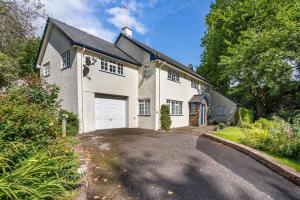 a large white house with a garage at 3 Bed in Scethrog oc-h30013 in Scethrog