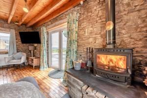 a living room with a fireplace in a log cabin at 3 Bed in Port Talbot oc-b30321 in Port Talbot