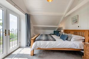 a bedroom with a bed and a large window at 3 Bed in Port Talbot oc-b30321 in Port Talbot