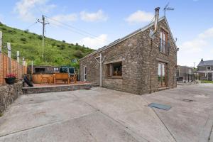 a stone house with a patio and a yard at 3 Bed in Port Talbot oc-b30321 in Port Talbot