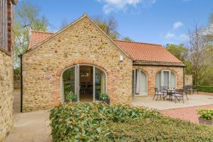a brick building with a patio with tables and chairs at 2 Bed in Crakehall oc-b30354 in Crakehall