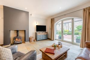 a living room with a fireplace and a tv at 2 Bed in Crakehall oc-b30354 in Crakehall