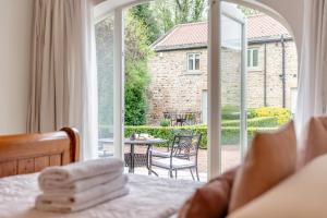 a bedroom with a bed and a view of a patio at 2 Bed in Crakehall oc-b30354 in Crakehall