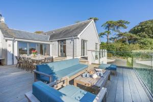 a patio with blue couches and a table on a deck at 5 Bed in Rock oc-m33185 in Roche