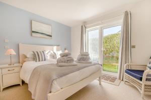 a bedroom with a bed and a large window at 5 Bed in Rock oc-m33185 in Roche +40 photos