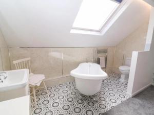 a bathroom with a tub and a sink and a toilet at 3 Bed in Ripon oc-t33753 in Ripon +10 photos
