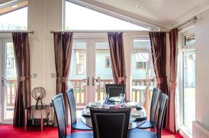 a dining room with a table and chairs and windows at 2 Bed in Stepaside oc-pw9184 in Stepaside
