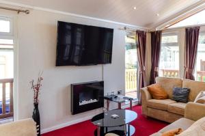 a living room with a couch and a fireplace at 2 Bed in Stepaside oc-pw9184 in Stepaside
