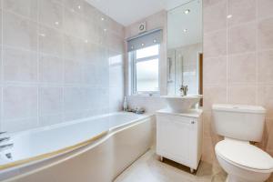 a bathroom with a tub and a toilet and a sink at 2 Bed in Stepaside oc-pw9184 in Stepaside +15 photos